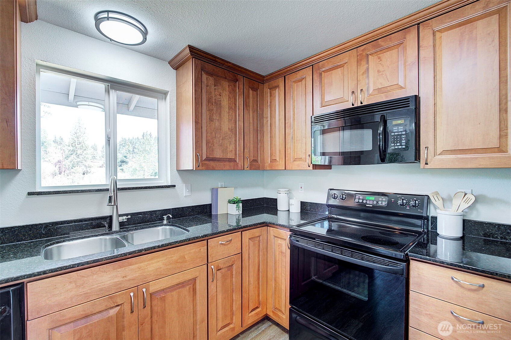 2019 181st Street Southeast Bothell, WA 98012 - Photo 7 of 23 a kitchen with stainless steel appliances granite countertop a sink stove and microwave