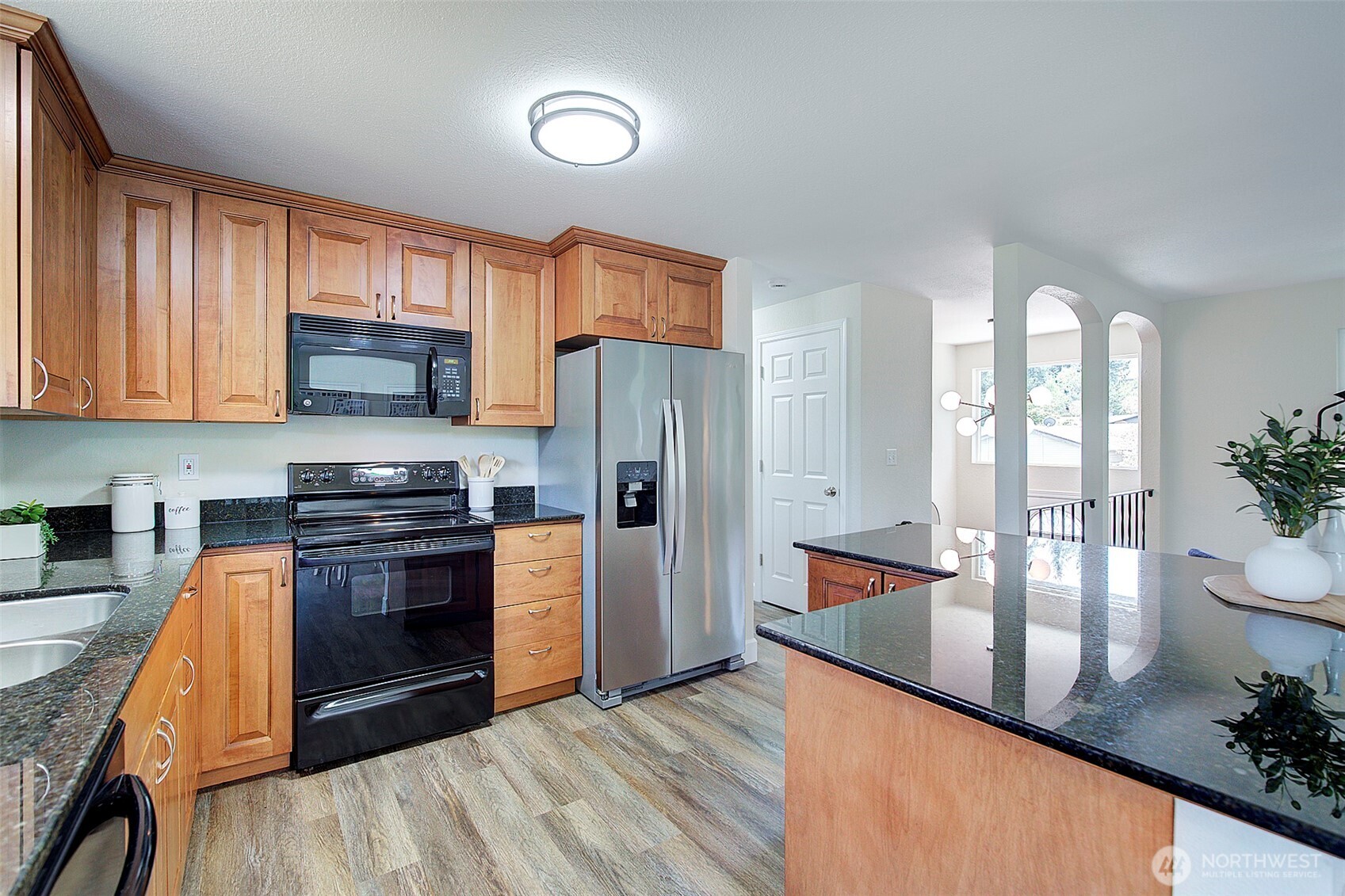 2019 181st Street Southeast Bothell, WA 98012 - Photo 9 of 23 a kitchen with stainless steel appliances granite countertop a stove a refrigerator and a view of living room