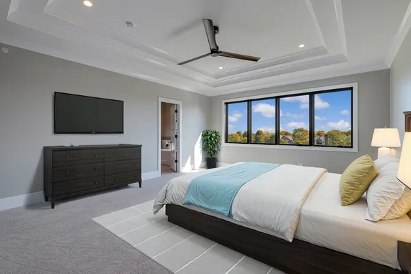 a bedroom with a bed and a flat screen tv