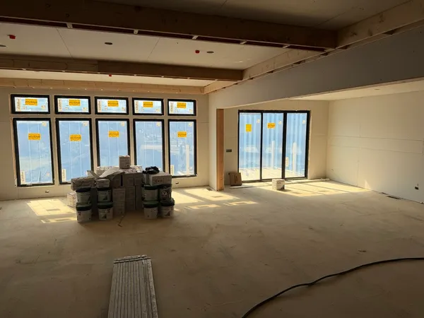 a living room with furniture and large windows