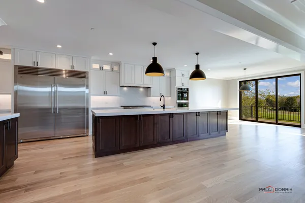 a kitchen with stainless steel appliances kitchen island wooden cabinets and granite counter tops