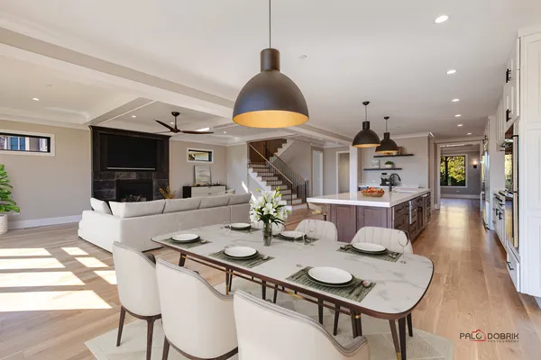 a dining room with furniture and a wooden floor