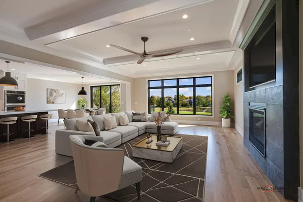 a living room with furniture fireplace and a large window