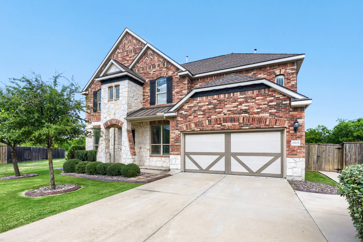 19205 Burrowbridge Road Pflugerville, TX 78660 - Photo 4 of 38 Stately brick and stone façade with detailed landscaping