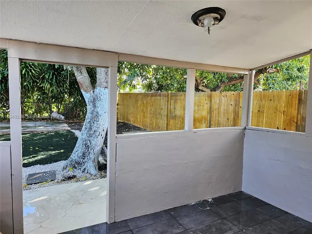 a living room with hardwood floor and a floor to ceiling window