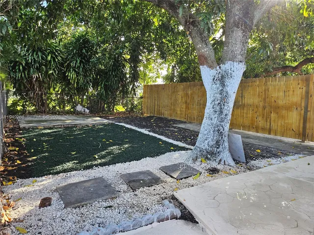 a view of a backyard with a tree