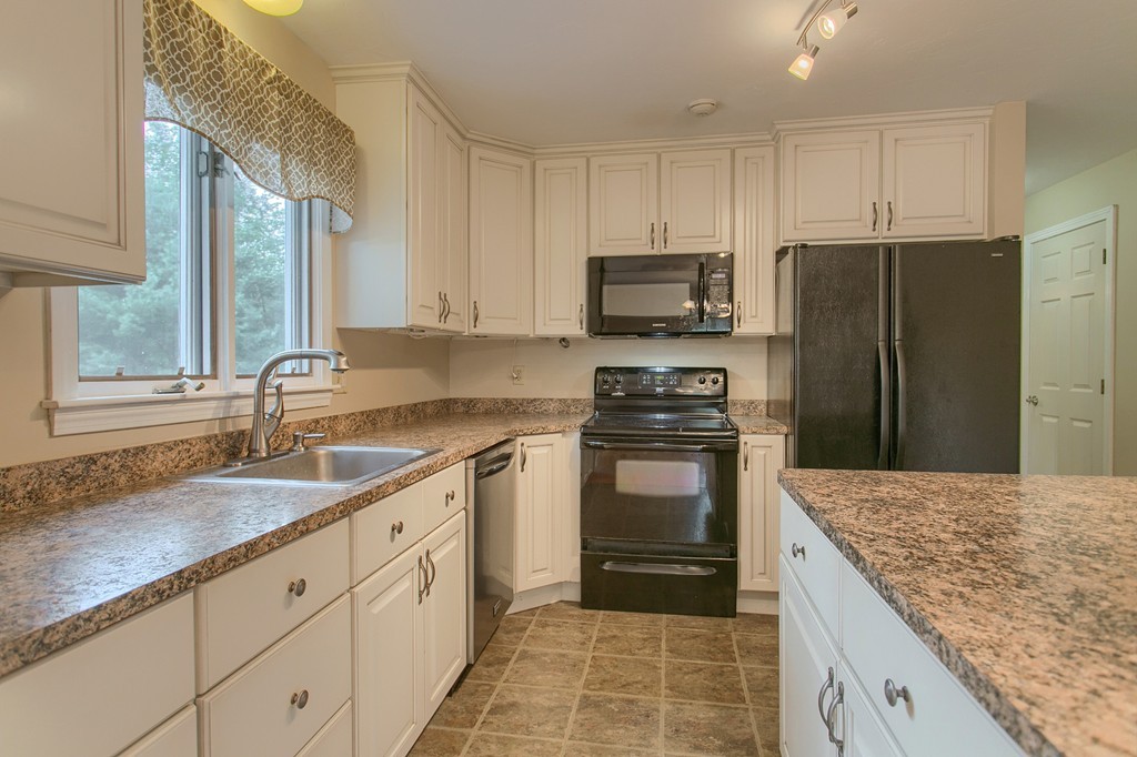 171 Northwest Road Spencer, MA 01562 - Photo 11 of 30 a kitchen with a sink stove and refrigerator