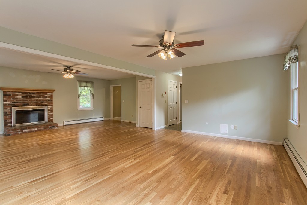 171 Northwest Road Spencer, MA 01562 - Photo 5 of 30 a view of empty room with wooden floor and fireplace