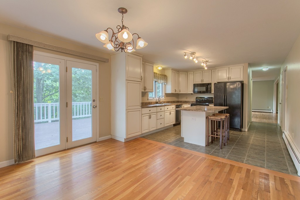 171 Northwest Road Spencer, MA 01562 - Photo 9 of 30 a kitchen with a refrigerator and a microwave