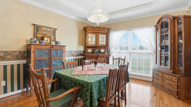 a view of a dining room with furniture window and wooden floor