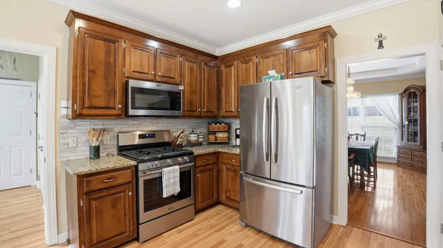 a kitchen with stainless steel appliances a refrigerator stove and microwave