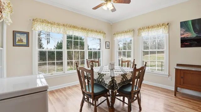 a view of a dining room with furniture window and wooden floor