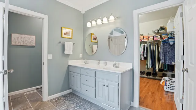 a bathroom with a double vanity sink and a mirror