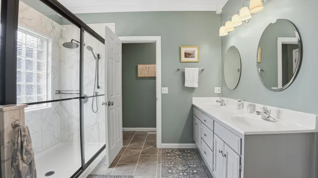 a bathroom with a double vanity sink mirror and double