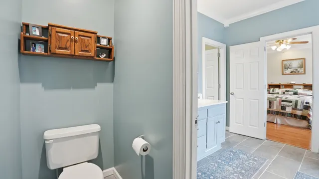 a bathroom with a toilet a sink and mirror