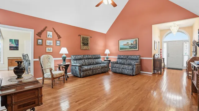 a living room with furniture and a wooden floor