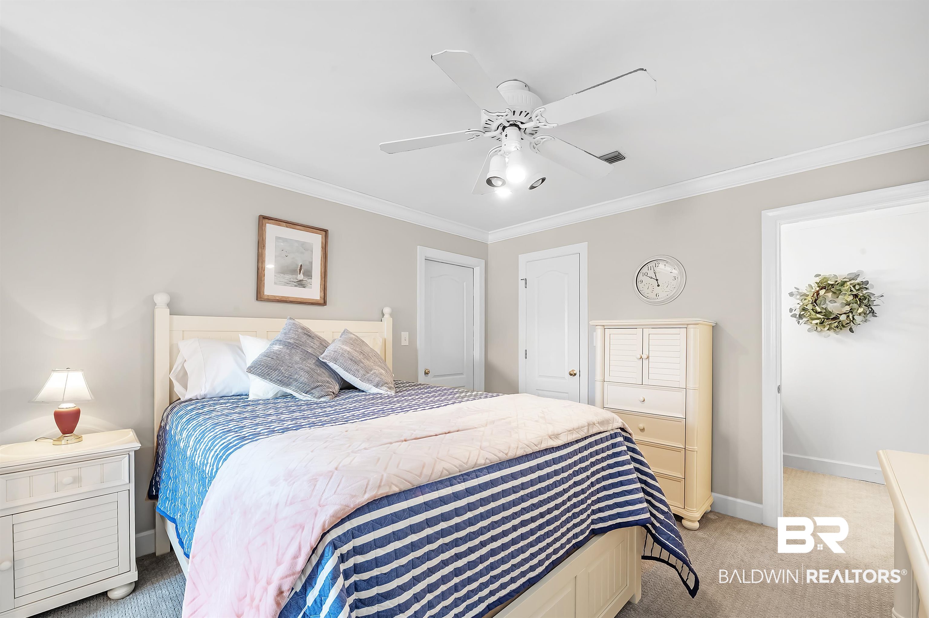 8915 Bay Point Drive Elberta, AL 36530 - Photo 64 of 74 Bedroom featuring light carpet, crown molding, baseboards, and ceiling fan