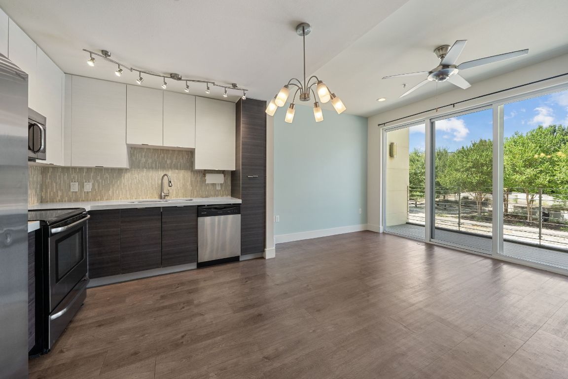a kitchen with stainless steel appliances granite countertop a stove a sink and a refrigerator