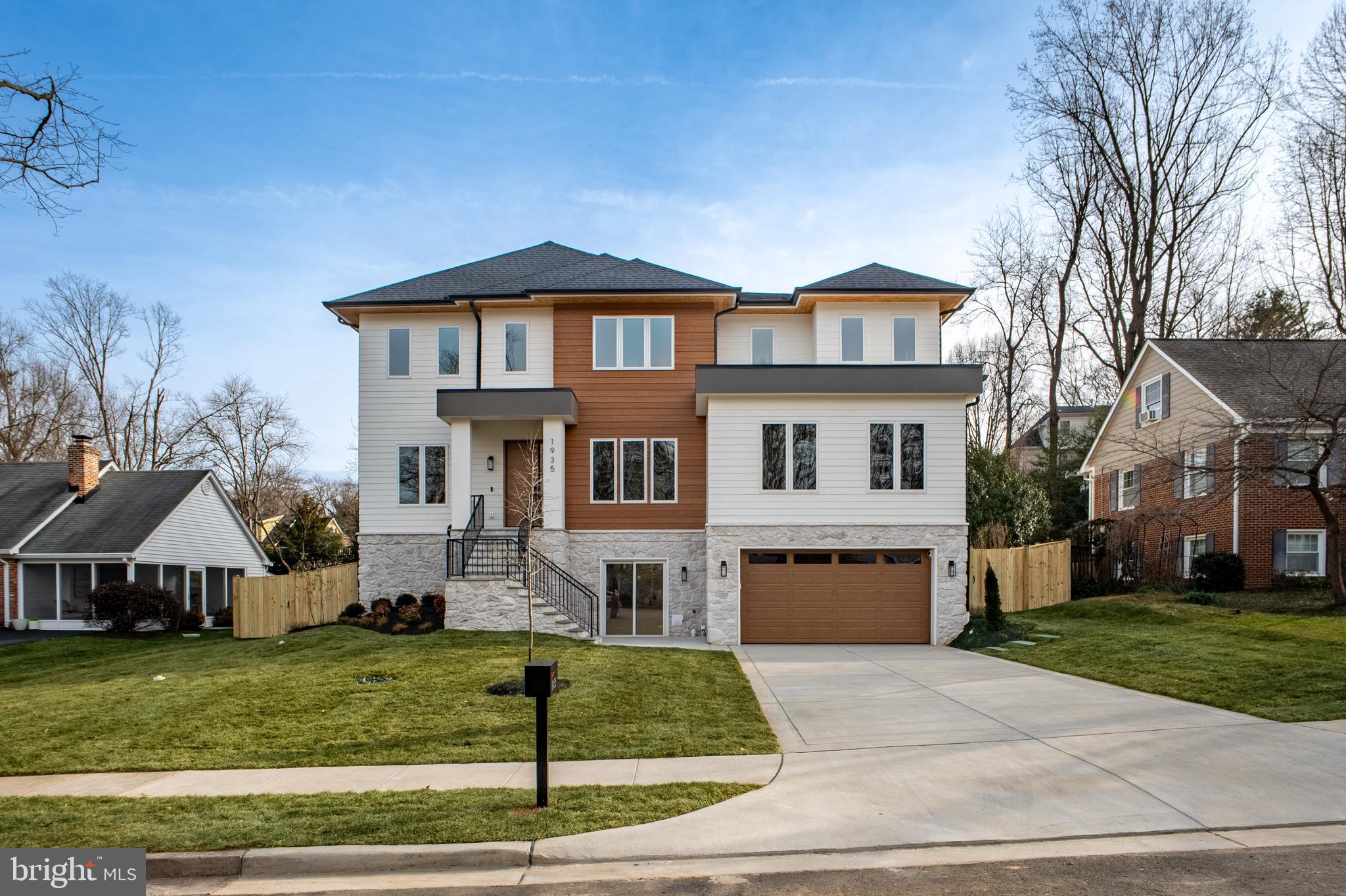 1935 Foxhall Road McLean, VA 22101 - Photo 2 of 80 a front view of a house with a yard and garage