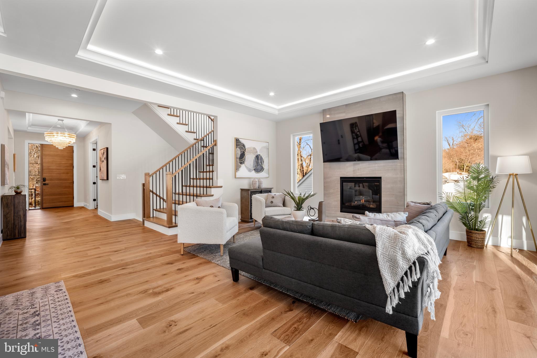 1935 Foxhall Road McLean, VA 22101 - Photo 23 of 80 a living room with furniture a flat screen tv and a fireplace