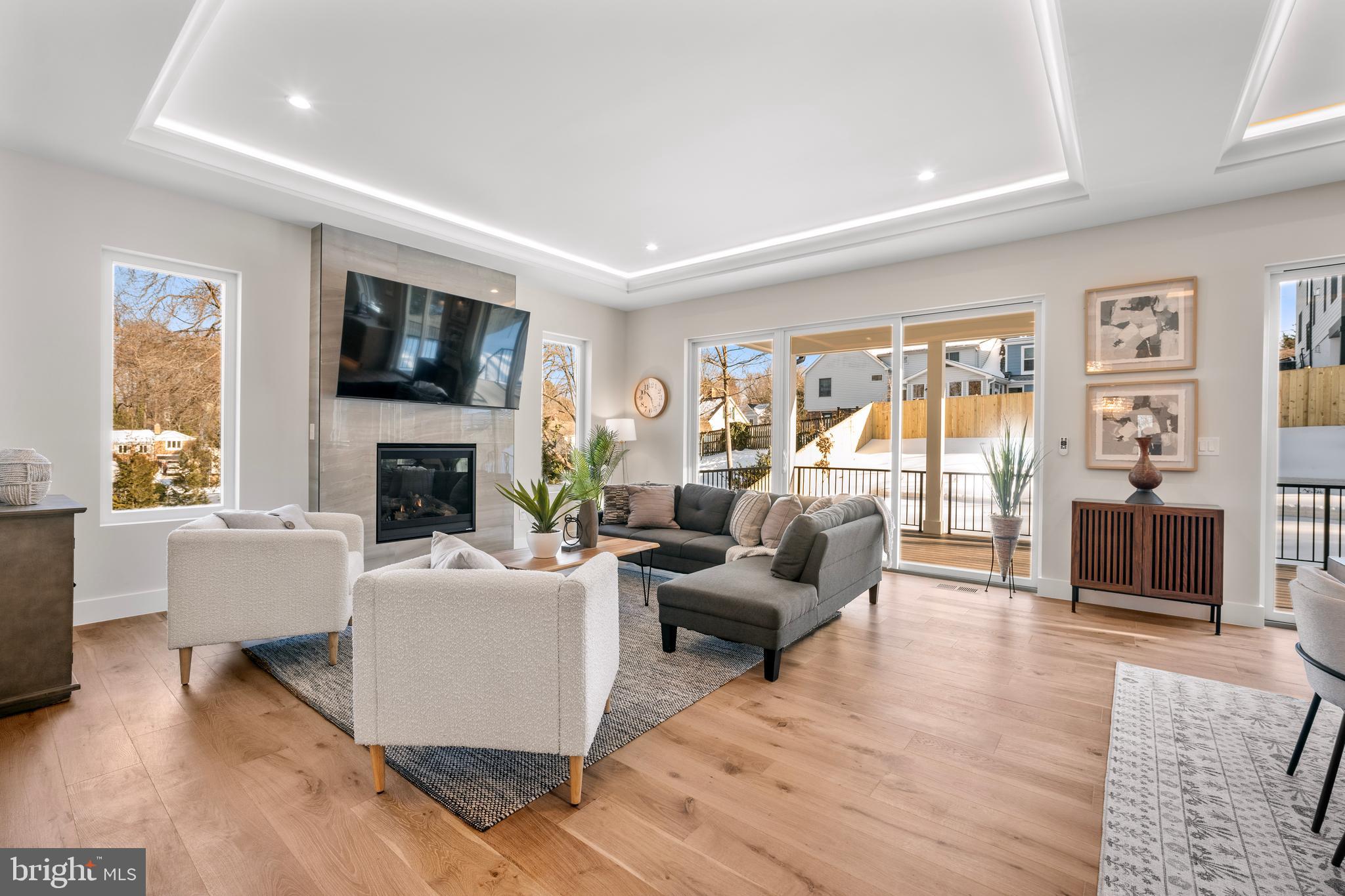 1935 Foxhall Road McLean, VA 22101 - Photo 25 of 80 a living room with furniture a flat screen tv and a fireplace