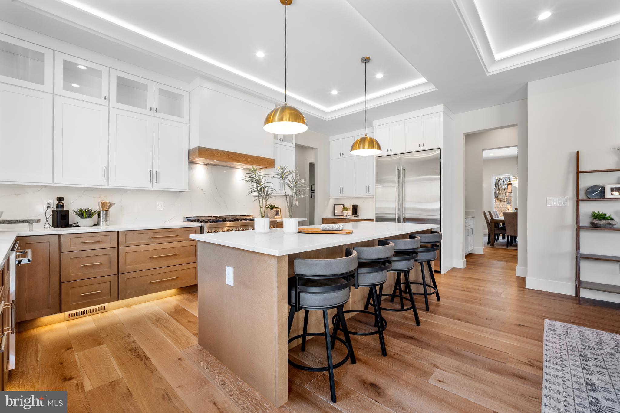 1935 Foxhall Road McLean, VA 22101 - Photo 31 of 80 a kitchen with stainless steel appliances kitchen island granite countertop a table chairs sink and cabinets