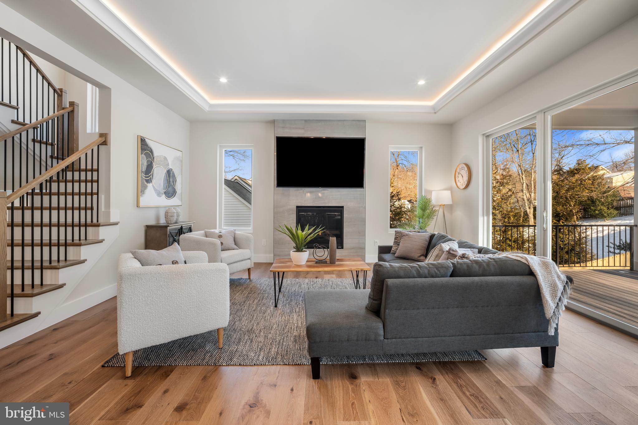 1935 Foxhall Road McLean, VA 22101 - Photo 35 of 80 a living room with furniture a flat screen tv and a fireplace