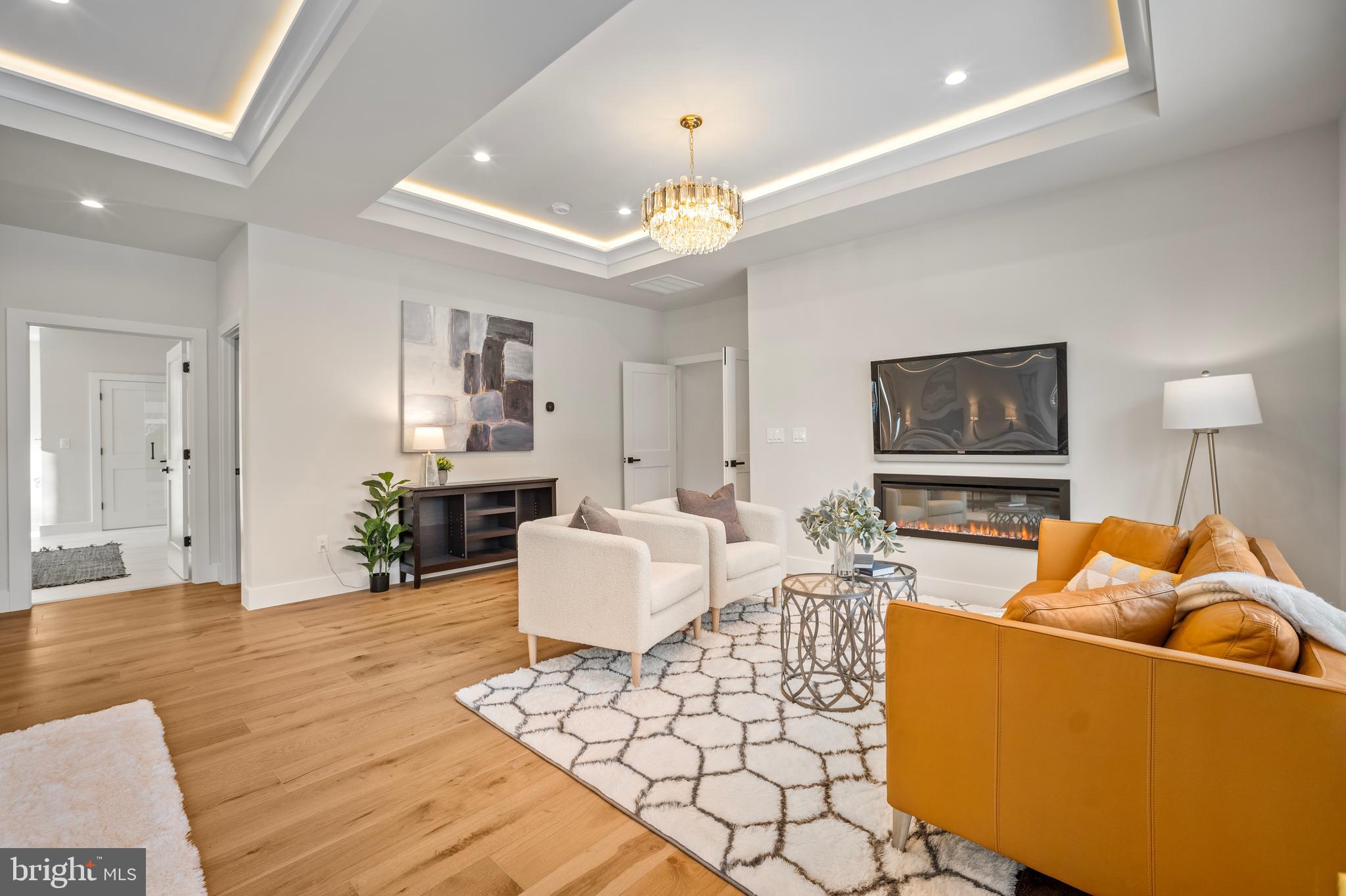 1935 Foxhall Road McLean, VA 22101 - Photo 44 of 80 a living room with furniture a chandelier and a dining room