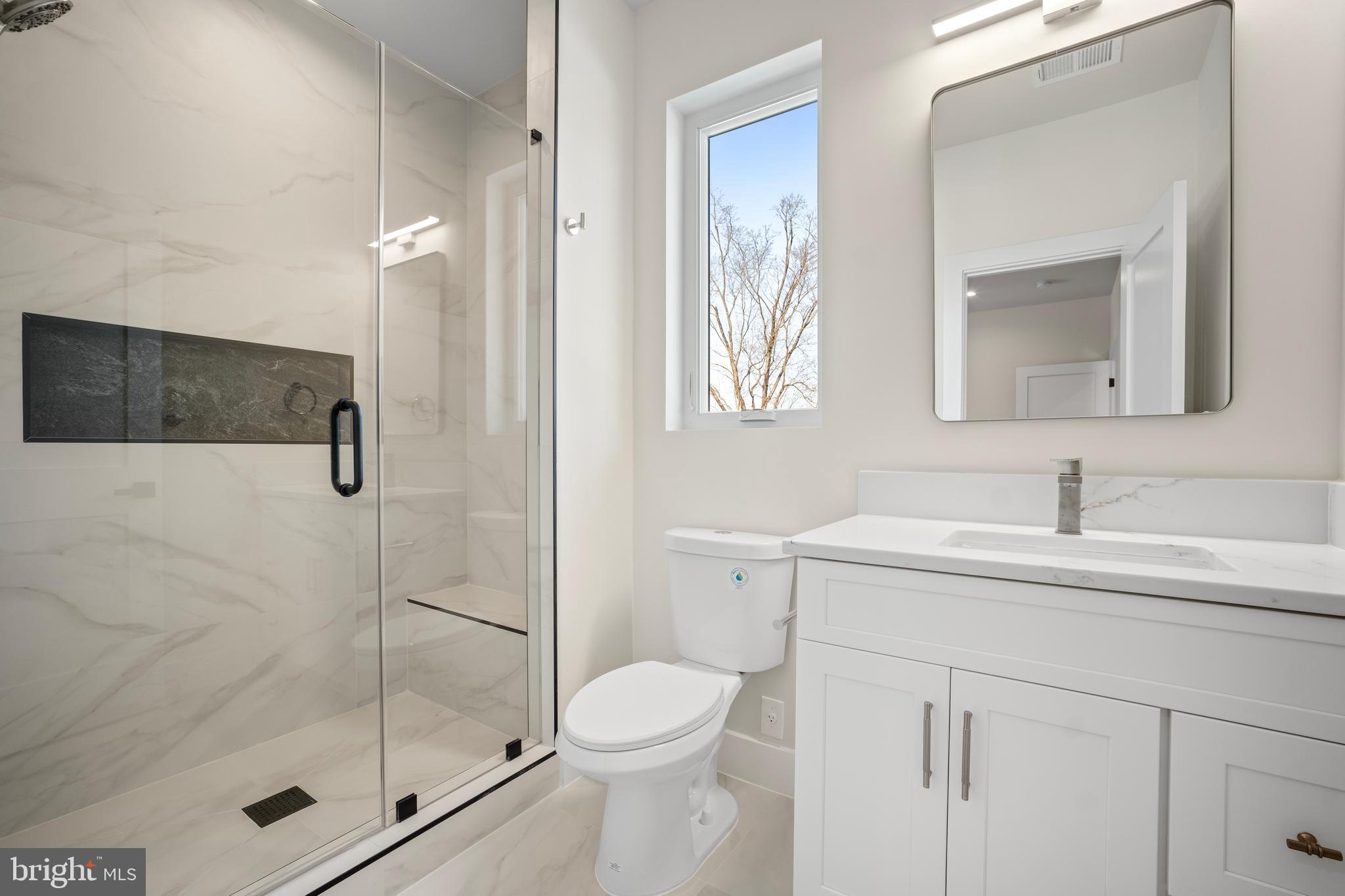 1935 Foxhall Road McLean, VA 22101 - Photo 53 of 80 a bathroom with a shower sink vanity mirror and toilet