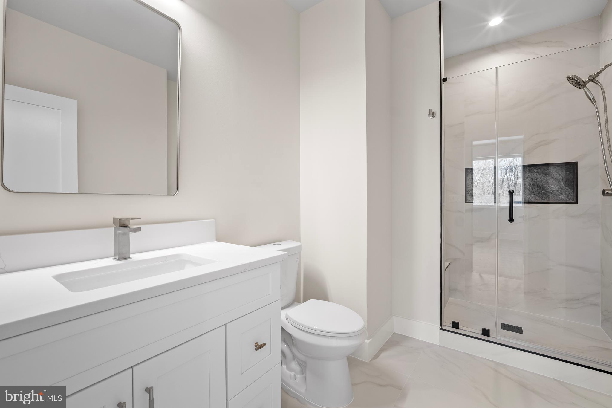 1935 Foxhall Road McLean, VA 22101 - Photo 56 of 80 a bathroom with a sink a toilet and shower