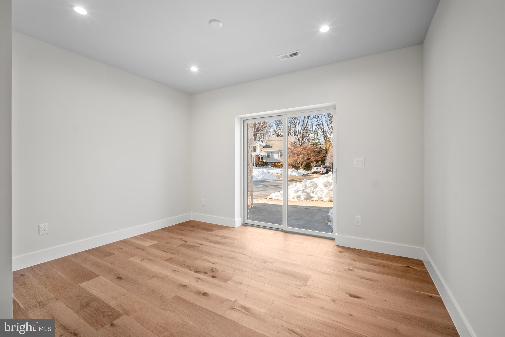 1935 Foxhall Road McLean, VA 22101 - Photo 68 of 80 an empty room with wooden floor and doors