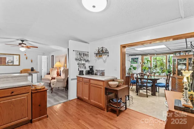 a living room with furniture large window and wooden floor