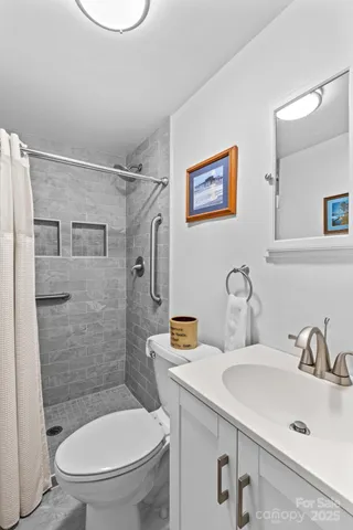 a bathroom with a sink toilet and shower
