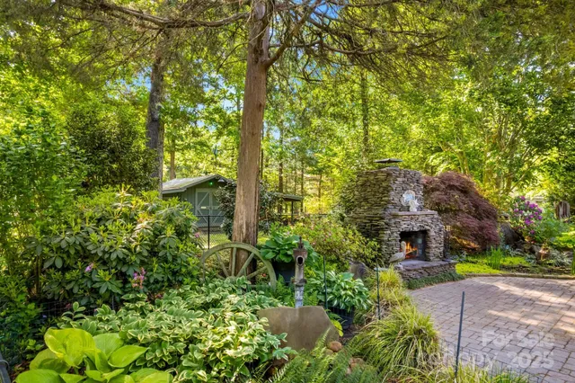 a aerial view of a house with a yard and large trees