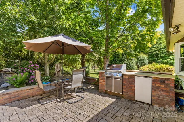 a view of backyard with plants and outdoor seating