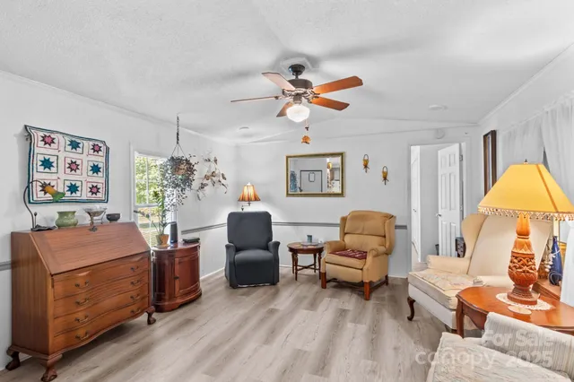 a bedroom with furniture and a chandelier