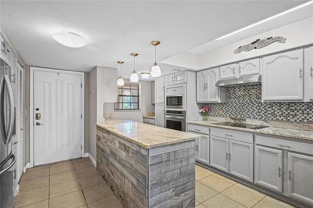a kitchen with granite countertop a sink and cabinets