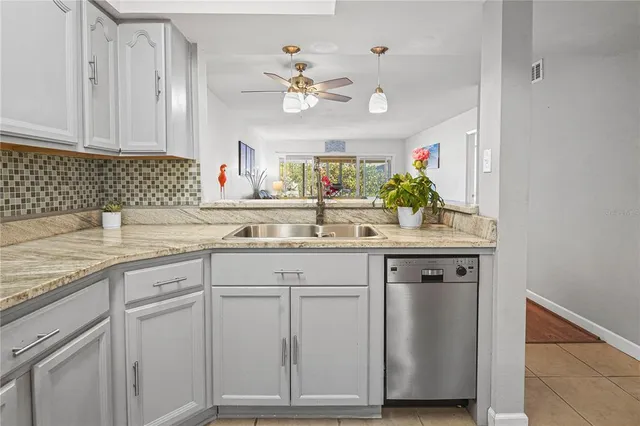 a kitchen with granite countertop white cabinets and white appliances