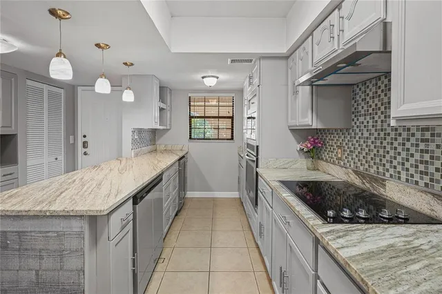 a kitchen with a sink stove and cabinets