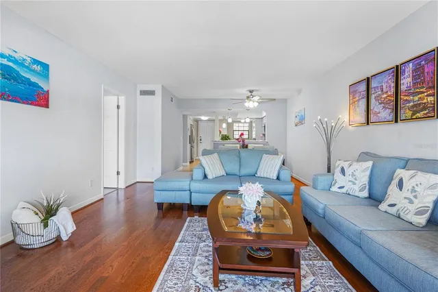 a living room with furniture rug and wooden floor