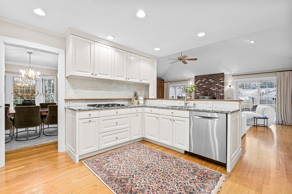 24 Garrison Road Wellesley, MA 02482 - Photo 15 of 32 a kitchen with granite countertop white cabinets and white appliances