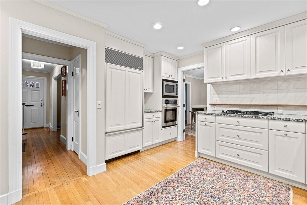 24 Garrison Road Wellesley, MA 02482 - Photo 17 of 32 a kitchen with stainless steel appliances granite countertop a refrigerator and a stove top oven