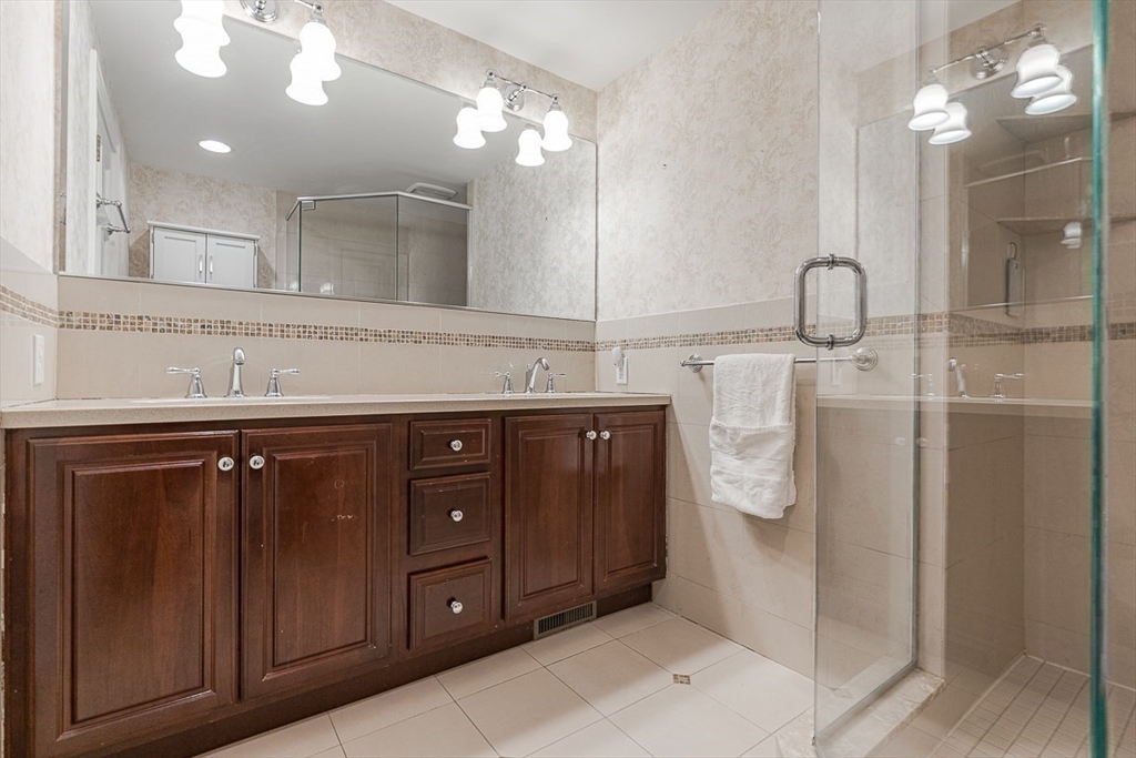 24 Garrison Road Wellesley, MA 02482 - Photo 23 of 32 a bathroom with a sink vanity and a mirror