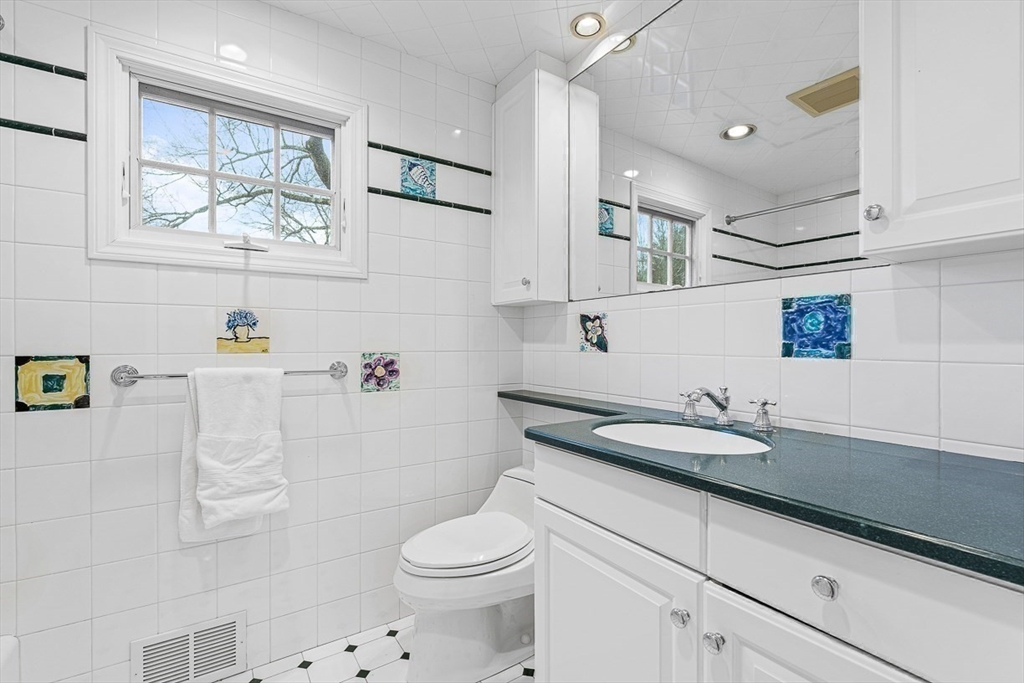 24 Garrison Road Wellesley, MA 02482 - Photo 25 of 32 a bathroom with a sink a toilet and a shower