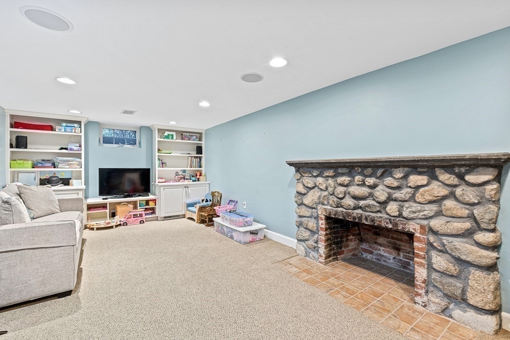 24 Garrison Road Wellesley, MA 02482 - Photo 28 of 32 a living room with furniture and a flat screen tv
