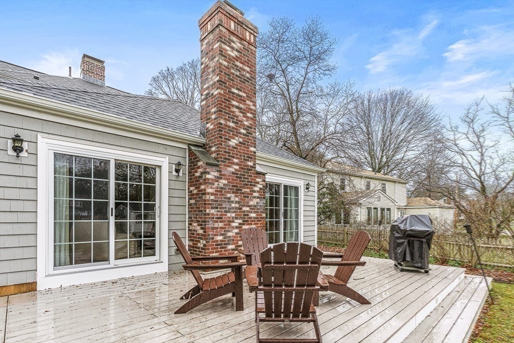 24 Garrison Road Wellesley, MA 02482 - Photo 29 of 32 a view of a patio with table and chairs and wooden floor