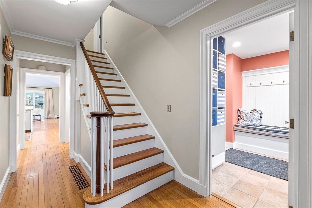 24 Garrison Road Wellesley, MA 02482 - Photo 3 of 32 a view of a hallway with wooden floor and staircase