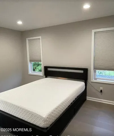 a bed sitting in a bedroom next to a window