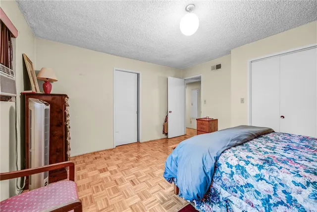 a bedroom with a bed and a mirror