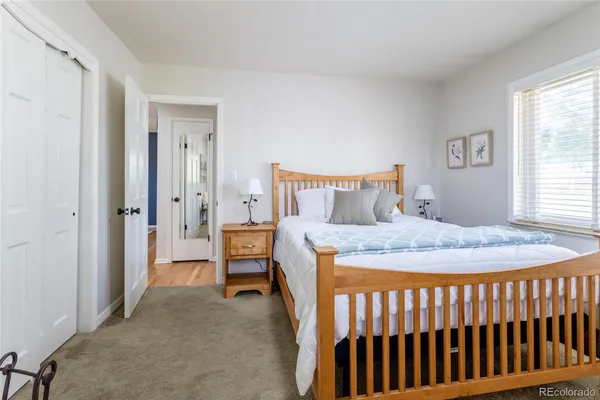 a bedroom with a bed and a table
